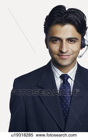 Stock Photography - Portrait of a male customer service representative smiling. Fotosearch