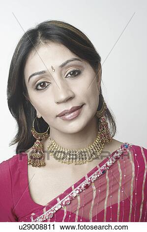 Stock Image - Portrait of a mid adult woman wearing a necklace. Fotosearch