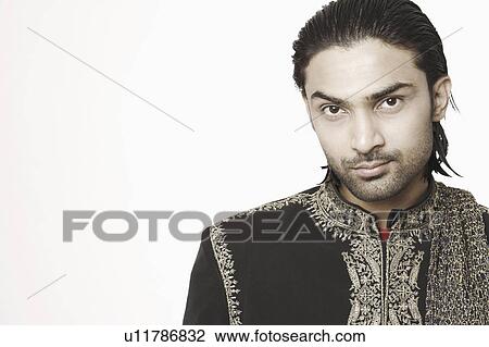Stock Image - Portrait of a young man in traditional clothing. Fotosearch