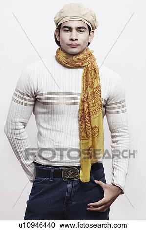 Portrait of a young man standing with his hands in his pockets View Large Photo Image Stock Image - Portrait of a young man standing with his hands in his pockets. Fotosearch