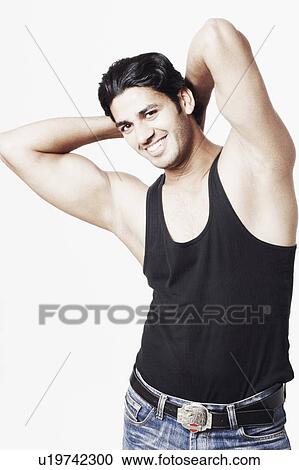 Portrait of a young man with his hands behind his head View Large Photo Image Stock Image - Portrait of a young man with his hands behind his head. Fotosearch