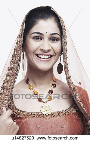 Stock Image - Portrait of a young woman in traditional clothing smiling. Fotosearch
