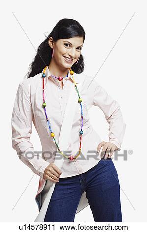 Portrait of a young woman posing and smiling View Large Photo Image Stock Image - Portrait of a young woman posing and smiling. Fotosearch
