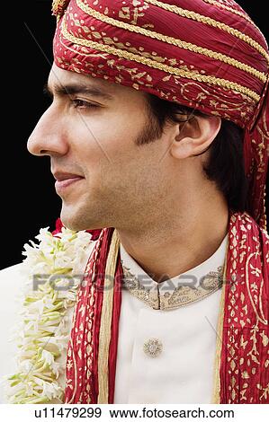 Stock Photo - Close-up of a groom in a traditional wedding dress. Fotosearch