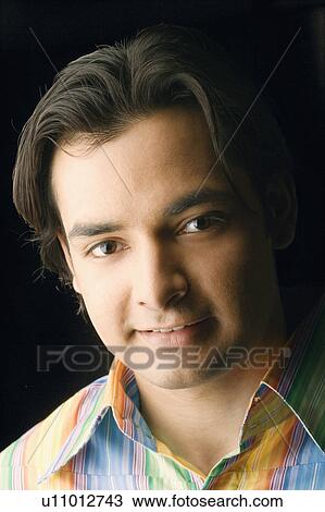 Portrait of a young man smirking View Large Photo Image Stock Image - Portrait of a young man smirking. Fotosearch