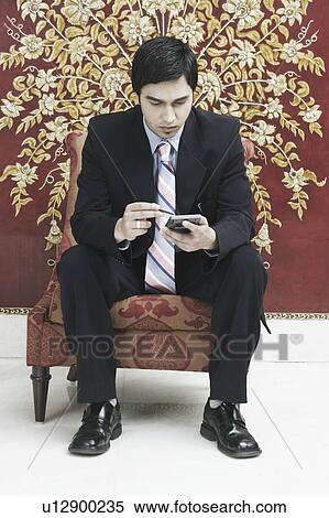 Businessman using a mobile phone View Large Photo Image Stock Photography - Businessman using a mobile phone. Fotosearch