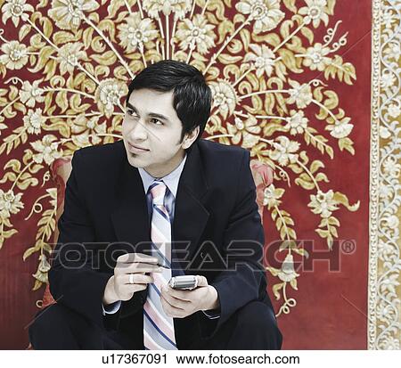 Close-up of a businessman using a mobile phone View Large Photo Image Stock Image - Close-up of a businessman using a mobile phone. Fotosearch