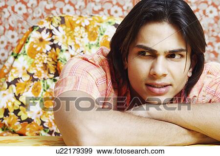Stock Photo - Close-up of a young man looking away. Fotosearch