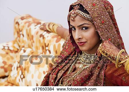 Portrait of a bride sitting on a couch View Large Photo Image Picture - Portrait of a bride sitting on a couch. Fotosearch