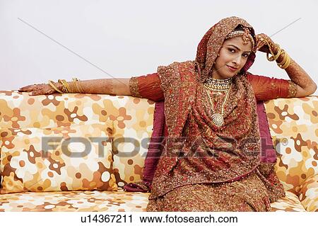 Portrait of a bride sitting on a couch View Large Photo Image Stock Image - Portrait of a bride sitting on a couch. Fotosearch