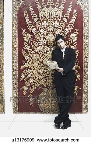 Portrait of a businessman holding a newspaper View Large Photo Image Stock Photo - Portrait of a businessman holding a newspaper. Fotosearch