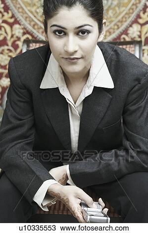Portrait of a businesswoman holding a mobile phone View Large Photo Image Stock Image - Portrait of a businesswoman holding a mobile phone. Fotosearch