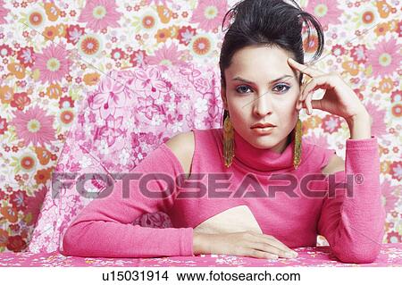 Portrait of a young woman with her finger on head View Large Photo Image Picture - Portrait of a young woman with her finger on head. Fotosearch