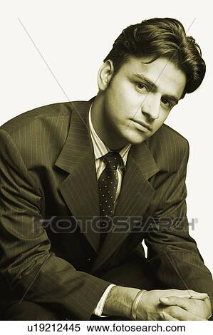 Stock Photography - Portrait of a businessman looking serious. Fotosearch