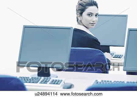 Picture - Portrait of a businesswoman working on a computer. Fotosearch