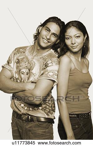 Portrait of a young man standing with a mid adult woman and smiling View Large Photo Image Stock Photography - Portrait of a young man standing with a mid adult woman and smiling. Fotosearch