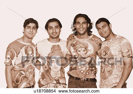 Picture - Portrait of four young men standing together and smiling. Fotosearch