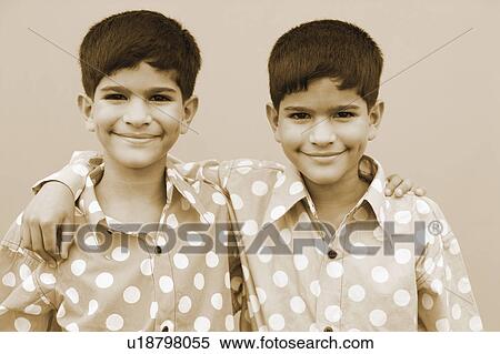 Portrait of twin brothers with their arms around each other View Large Photo Image Stock Photography - Portrait of twin brothers with their arms around each other. Fotosearch