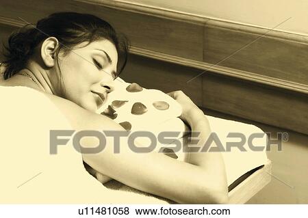 Stock Photo - Rear view of a young woman lying on a massage table. Fotosearch