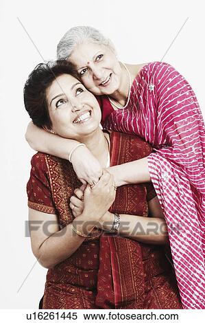 Close-up of a mature woman hugging her daughter from behind View Large Photo Image Stock Photography - Close-up of a mature woman hugging her daughter from behind. Fotosearch
