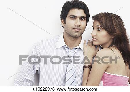 Stock Photo - Portrait of a businessman standing with a young woman leaning on him. Fotosearch