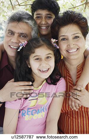 Portrait of a mature couple and their two grandchildren smiling View Large Photo Image Stock Photo - Portrait of a mature couple and their two grandchildren smiling. Fotosearch