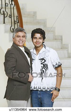 Portrait of a mature man and his son smiling View Large Photo Image Picture - Portrait of a mature man and his son smiling. Fotosearch