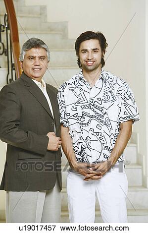 Portrait of a mature man and his son smiling View Large Photo Image Stock Photo - Portrait of a mature man and his son smiling. Fotosearch
