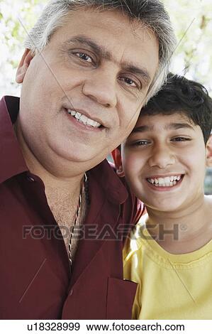 Portrait of a mature man and his grandson smiling View Large Photo Image Stock Photo - Portrait of a mature man and his grandson smiling. Fotosearch