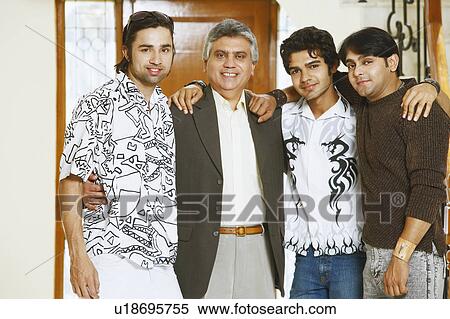 Stock Photography - Portrait of a mature man and his three sons smiling. Fotosearch