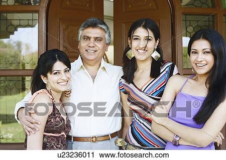 Portrait of a mature man standing with his three daughters View Large Photo Image Stock Image - Portrait of a mature man standing with his three daughters. Fotosearch