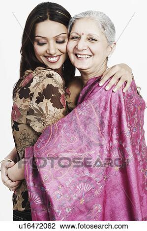 Stock Image - Portrait of a mature woman hugging her granddaughter. Fotosearch