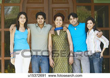 Portrait of a mature woman standing with her four children View Large Photo Image Stock Image - Portrait of a mature woman standing with her four children. Fotosearch
