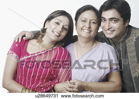 Stock Image - Portrait of a mid adult couple and a mature woman smiling. Fotosearch