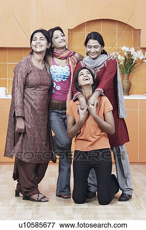 Stock Photo - Portrait of a mother and her three daughters smiling. Fotosearch