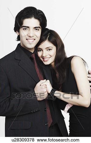 Stock Photo - Portrait of a young couple holding hands. Fotosearch