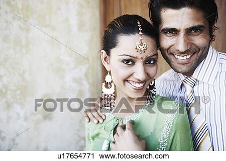 Stock Image - Portrait of a young couple smiling. Fotosearch