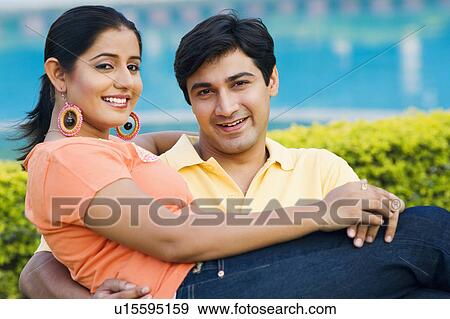 Portrait of a young man carrying a young woman and smiling View Large Photo Image Stock Photo - Portrait of a young man carrying a young woman and smiling. Fotosearch