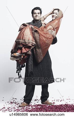 Portrait of a young man carrying a young woman View Large Photo Image Stock Photograph - Portrait of a young man carrying a young woman. Fotosearch