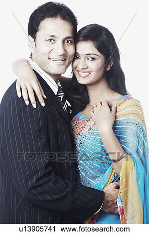 Stock Image - Portrait of a young man embracing a young woman. Fotosearch