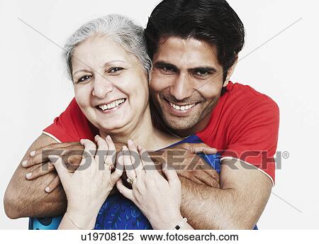 Portrait of a young man hugging his grandmother from behind View Large Photo Image Stock Photography - Portrait of a young man hugging his grandmother from behind. Fotosearch