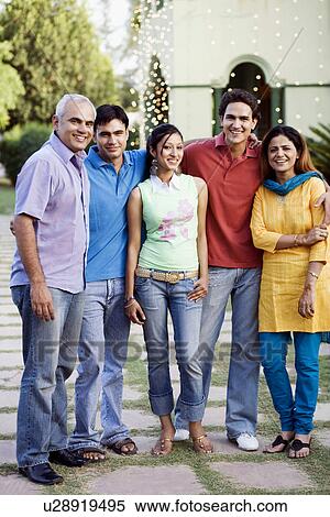 Stock Photography - Portrait of five people standing together and smiling. Fotosearch