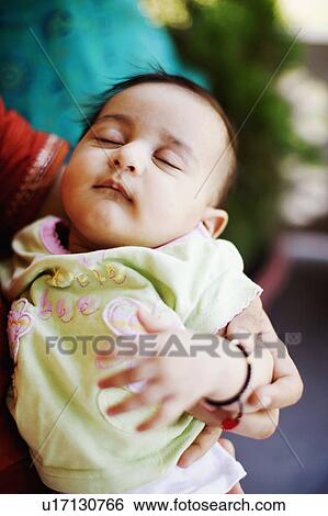Stock Photograph - Close-up of a baby girl sleeping. Fotosearch