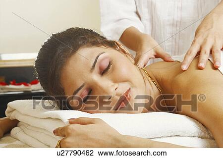 Close-up of a young woman getting a shoulder massage from a massage therapist View Large Photo Image Stock Image - Close-up of a young woman getting a shoulder massage from a massage therapist. Fotosearch
