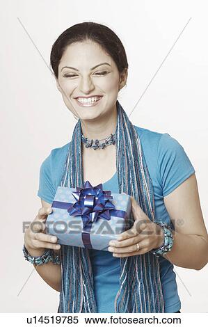 Close-up of a young woman holding a gift box View Large Photo Image Stock Photography - Close-up of a young woman holding a gift box. Fotosearch