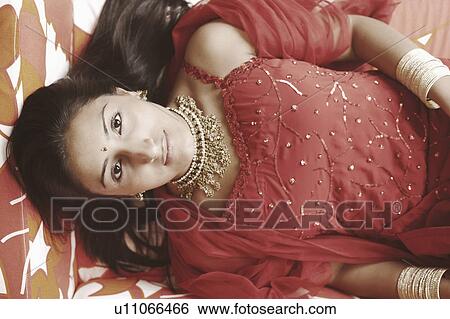 High angle view of a young woman lying on the bed View Large Photo Image Stock Photograph - High angle view of a young woman lying on the bed. Fotosearch