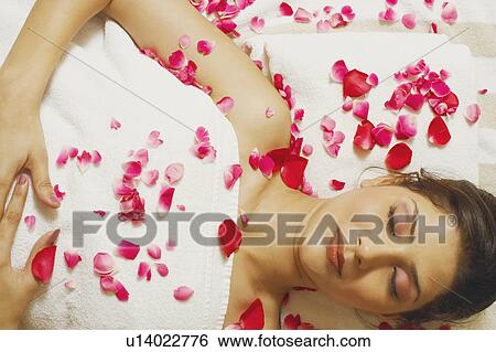 Stock Photograph - High angle view of a young woman lying on a massage table. Fotosearch