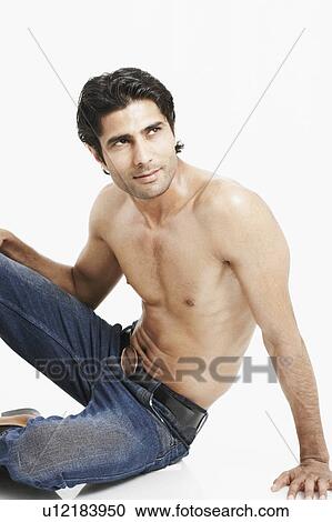 Close-up of a young man sitting on the floor bare chested View Large Photo Image Stock Image - Close-up of a young man sitting on the floor bare chested. Fotosearch