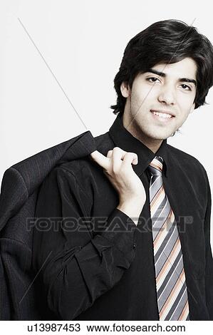 Portrait of a businessman holding his coat over his shoulder View Large Photo Image Stock Image - Portrait of a businessman holding his coat over his shoulder. Fotosearch