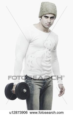 Portrait of a young man holding a dumbbell View Large Photo Image Stock Photograph - Portrait of a young man holding a dumbbell. Fotosearch